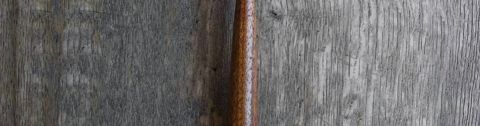A wooden gavel beside a jury summons indicating legal penalties