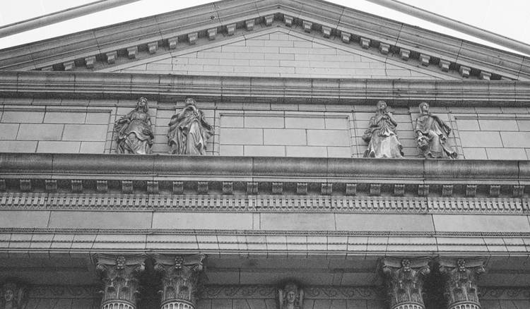 Ontario courthouse exterior beside a citizen reviewing a jury summons letter