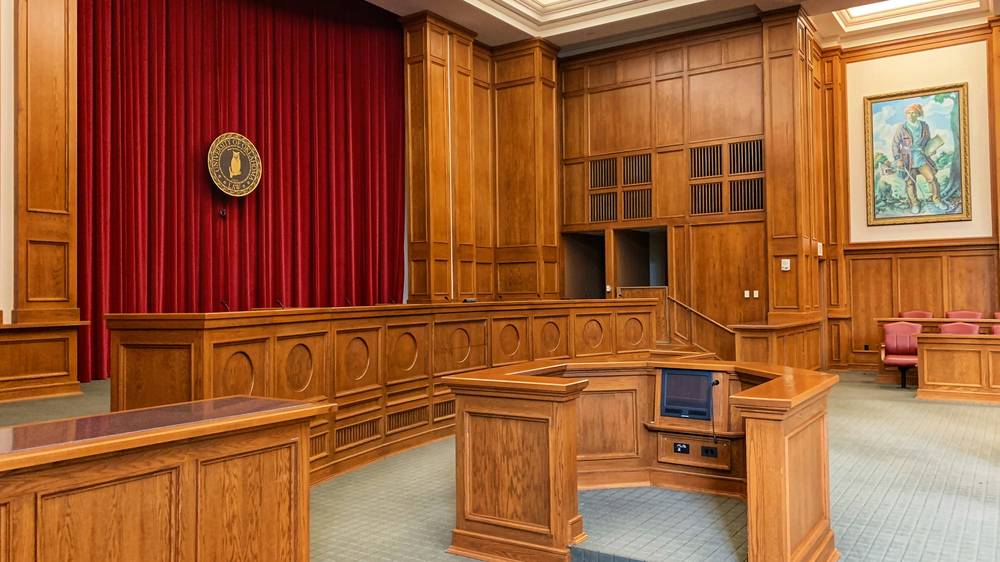 Judge’s gavel beside a chart showing escalating fines for jury duty no-shows