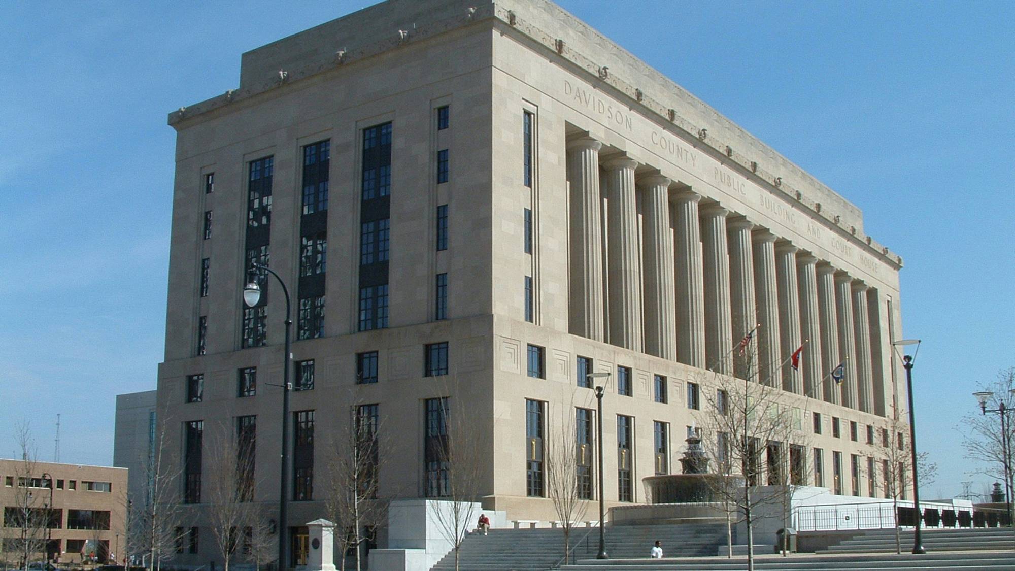 Muted courthouse façade representing official jury summons context